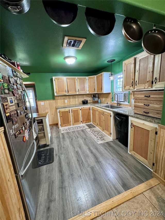 kitchen with dishwasher, light brown cabinets, sink, decorative light fixtures, and stainless steel refrigerator