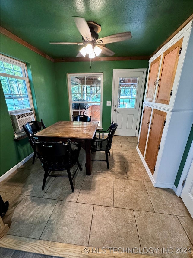 tiled dining space with ceiling fan, cooling unit, and a textured ceiling