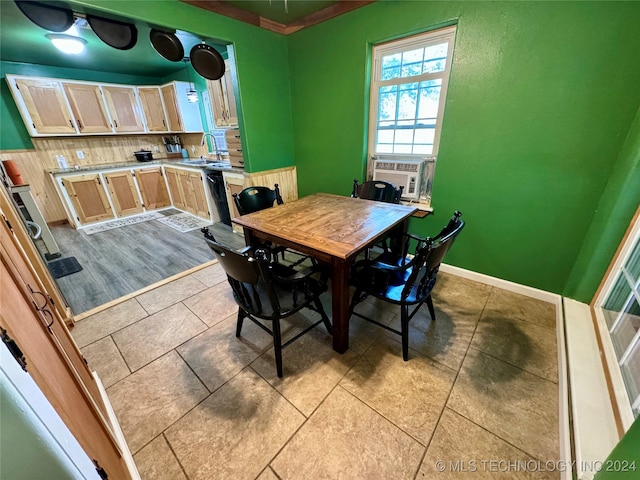 dining room featuring light tile patterned floors, cooling unit, and sink