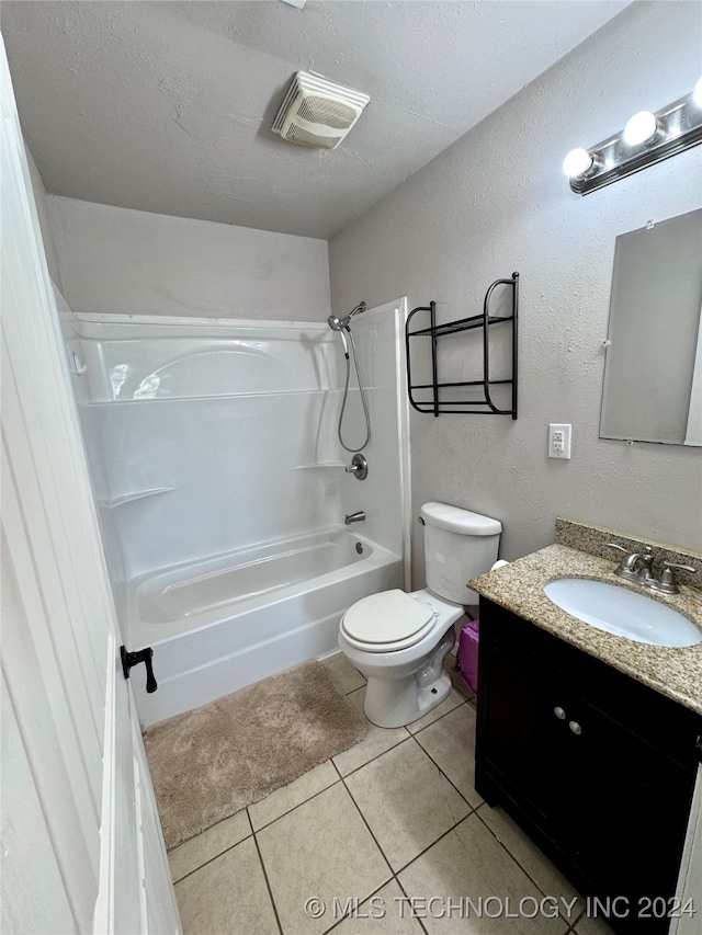 full bathroom featuring vanity, tile patterned floors, a textured ceiling, toilet, and shower / bathing tub combination