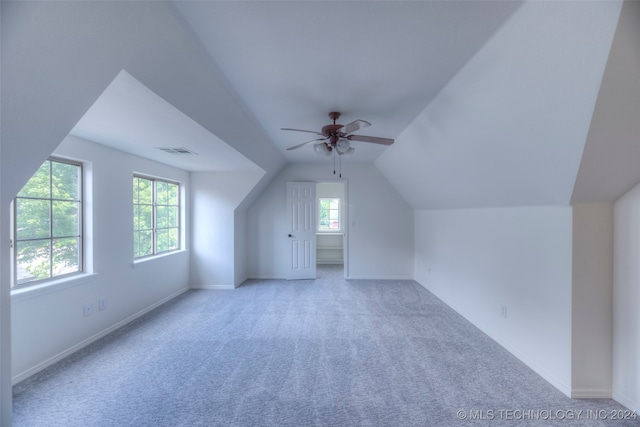 bonus room featuring ceiling fan, light carpet, and vaulted ceiling