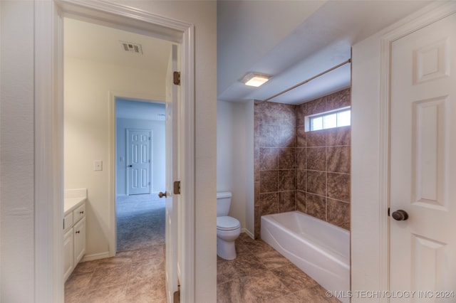 full bathroom featuring tiled shower / bath, toilet, tile patterned floors, and vanity