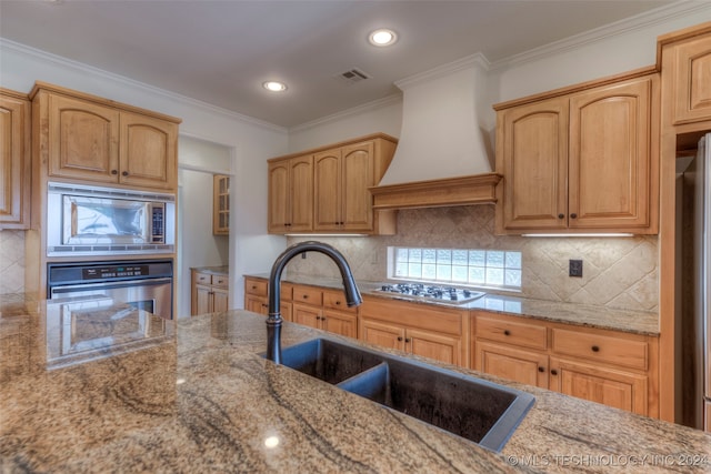 kitchen with custom range hood, appliances with stainless steel finishes, ornamental molding, tasteful backsplash, and light stone counters