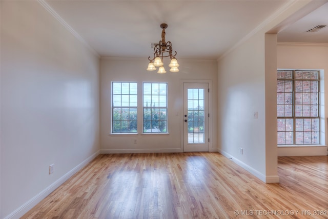 interior space featuring light hardwood / wood-style floors, an inviting chandelier, and ornamental molding