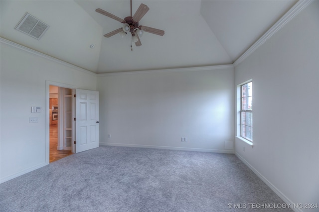 empty room with carpet, high vaulted ceiling, crown molding, and ceiling fan