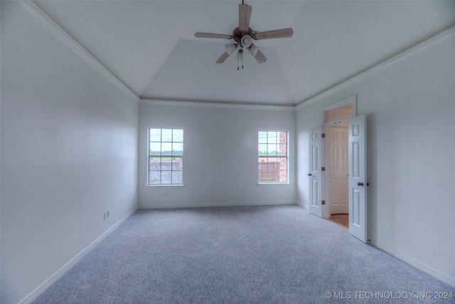 carpeted spare room featuring ceiling fan, crown molding, and lofted ceiling