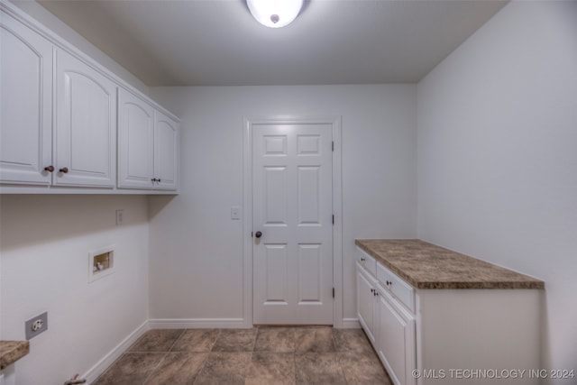 washroom featuring light tile patterned flooring, washer hookup, and cabinets