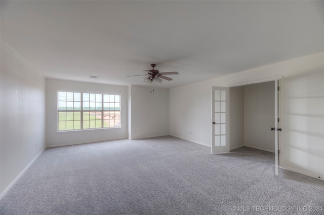 unfurnished bedroom featuring ceiling fan, french doors, and light carpet