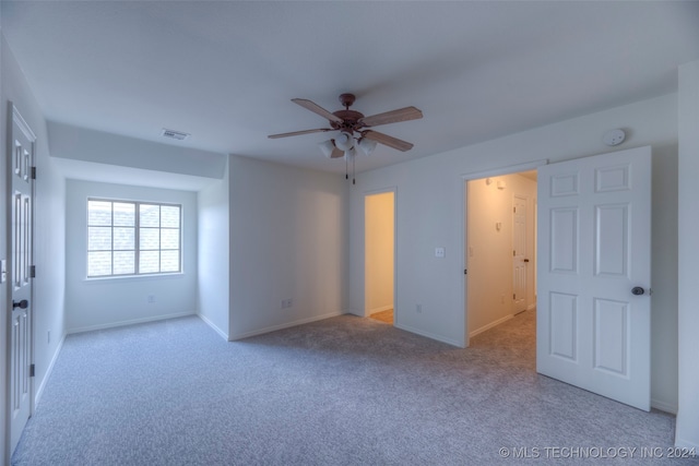 interior space with ceiling fan and light carpet