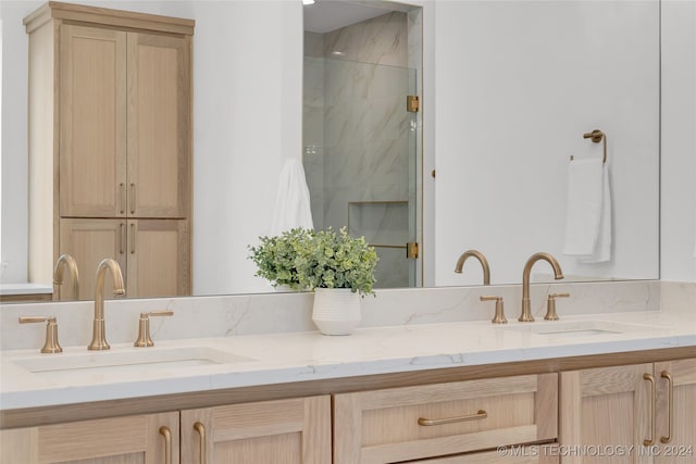 bathroom with an enclosed shower and vanity