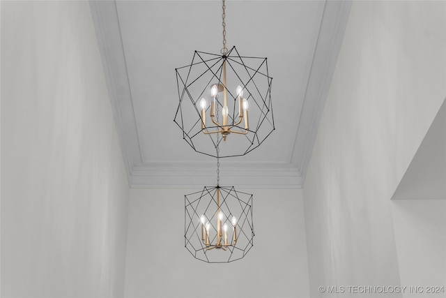 details featuring crown molding and an inviting chandelier