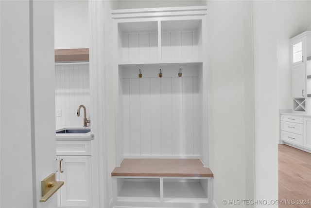 mudroom featuring sink and light hardwood / wood-style flooring