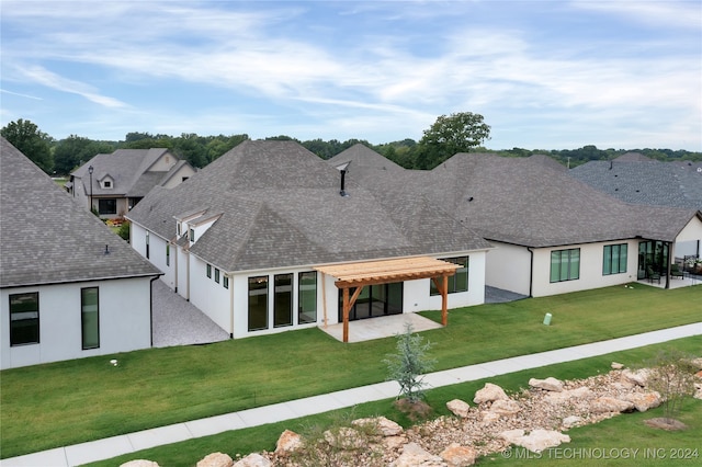 view of front of property featuring a front lawn and a patio area