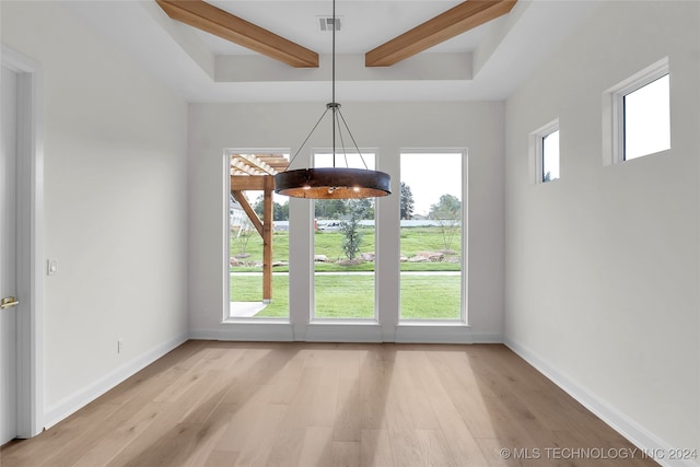 unfurnished dining area with beam ceiling and light hardwood / wood-style flooring