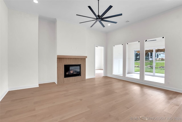 unfurnished living room featuring ceiling fan and light wood-type flooring