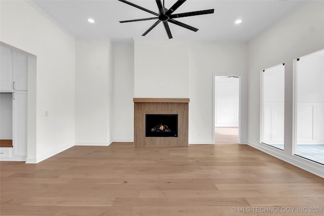 unfurnished living room featuring light hardwood / wood-style flooring, ceiling fan, and crown molding