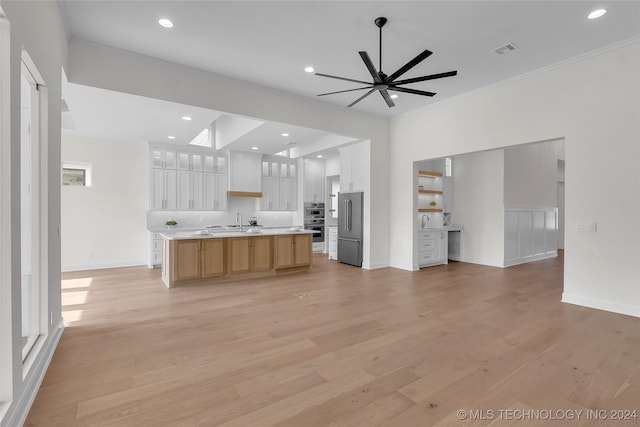 kitchen featuring light hardwood / wood-style flooring, a kitchen island with sink, ceiling fan, white cabinetry, and stainless steel appliances