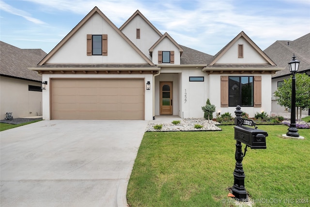 view of front facade with a front yard and a garage