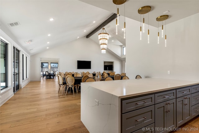 kitchen with light hardwood / wood-style flooring, beamed ceiling, gray cabinets, high vaulted ceiling, and an inviting chandelier