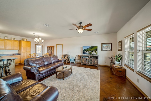 living area featuring baseboards, visible vents, and a healthy amount of sunlight