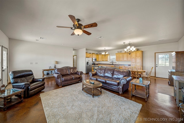 living area with visible vents and ceiling fan with notable chandelier