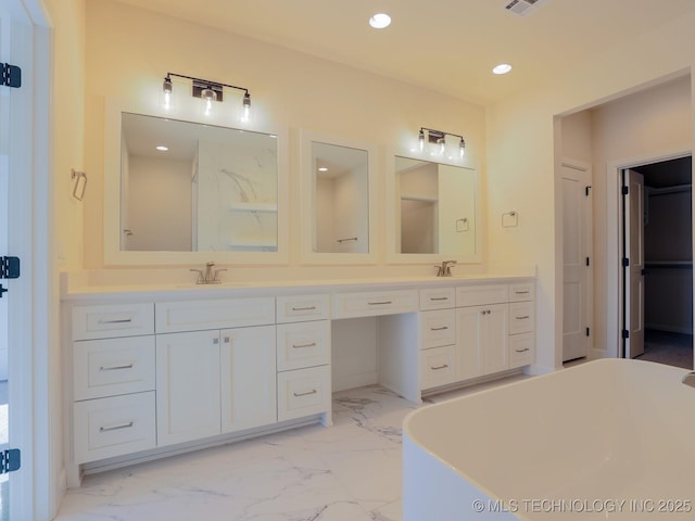 bathroom with recessed lighting, marble finish floor, a sink, and double vanity