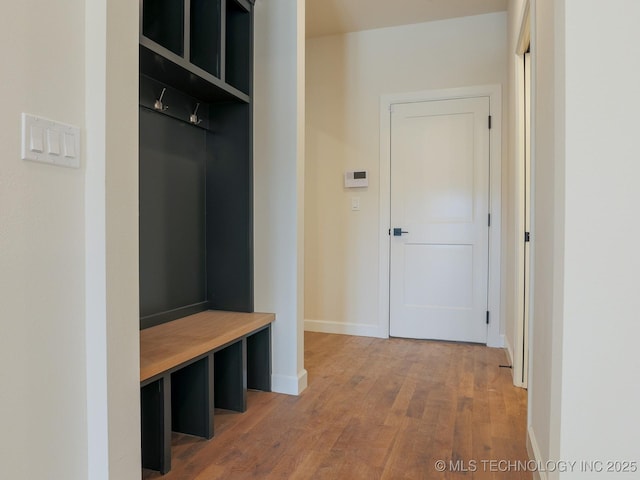 mudroom with baseboards and light wood-style floors