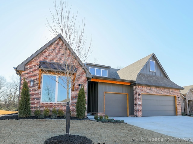 view of front of house featuring a garage, brick siding, a shingled roof, concrete driveway, and board and batten siding