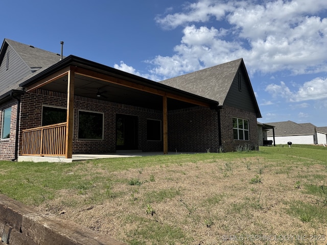 807 E Jacksonville St, Broken Arrow, OK 74012 - back of house featuring brick siding, a patio area, a lawn, ceiling fan, and roof with shingles