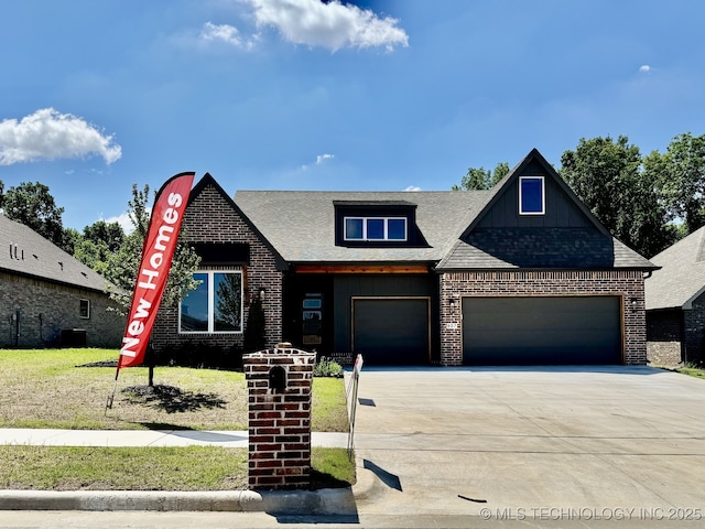 807 E Jacksonville St, Broken Arrow, OK 74012 - view of front of house featuring driveway, board and batten siding, an attached garage, and brick siding