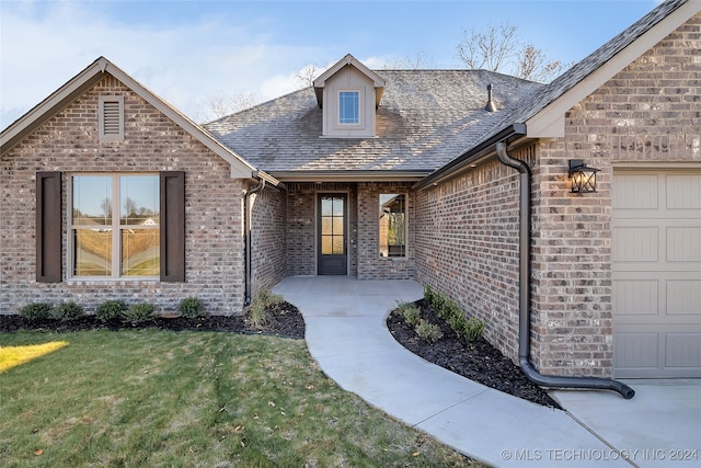 exterior space with a garage and a front lawn