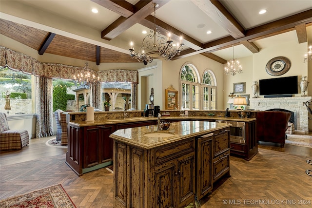 kitchen with beamed ceiling, a center island, parquet floors, and sink