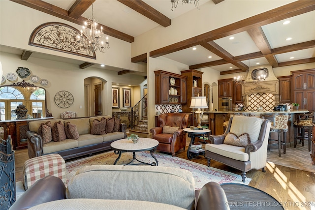 living room with a notable chandelier, beamed ceiling, wood-type flooring, and coffered ceiling