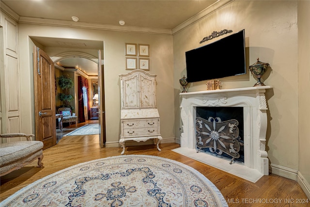 sitting room featuring hardwood / wood-style floors and ornamental molding