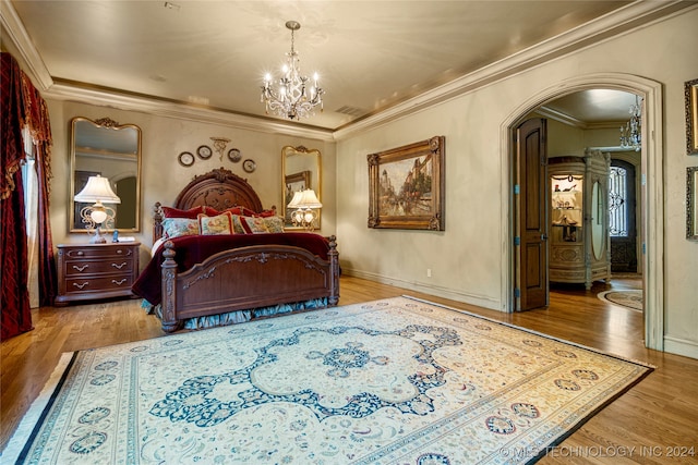 bedroom with a chandelier, ornamental molding, and wood-type flooring