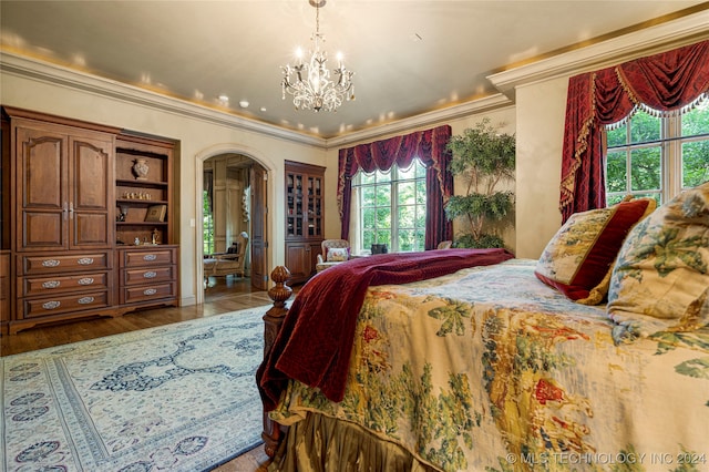 bedroom with hardwood / wood-style flooring, a chandelier, and ornamental molding