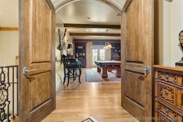 interior space featuring billiards, ornamental molding, beamed ceiling, and light wood-type flooring