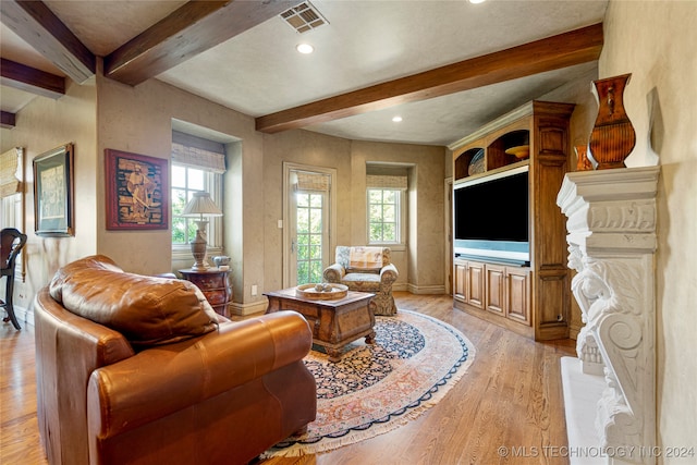 living room featuring beam ceiling and light hardwood / wood-style floors