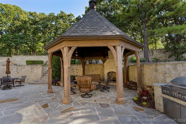 view of patio featuring a grill and a gazebo