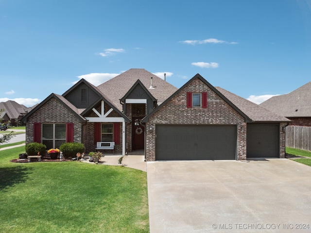 view of front of property featuring cooling unit, a garage, and a front lawn