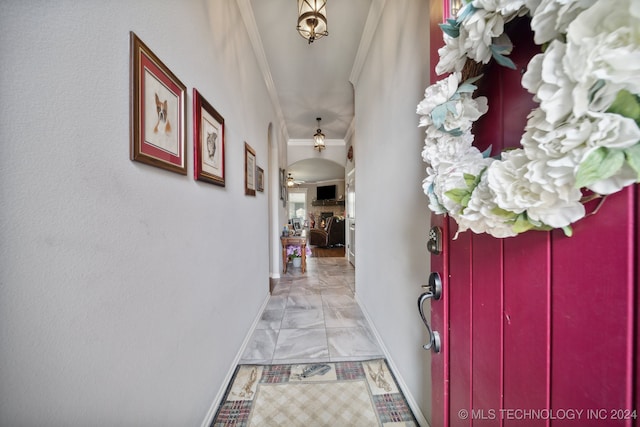 hallway featuring light tile patterned floors and ornamental molding