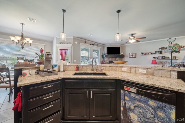 kitchen with ceiling fan with notable chandelier, dishwasher, light tile patterned floors, sink, and decorative light fixtures