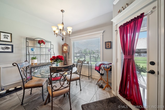 dining room featuring a chandelier and light tile patterned floors