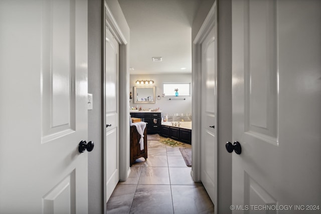 hall with light tile patterned floors