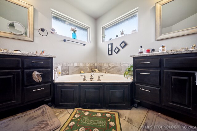 bathroom with a washtub and vanity