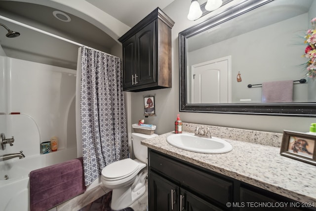 full bathroom with toilet, shower / tub combo with curtain, tile patterned floors, and vanity