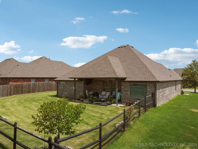 back of property featuring a lawn