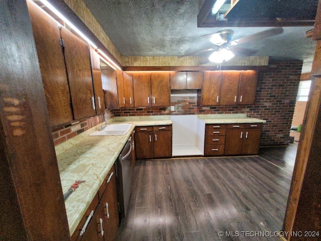 kitchen featuring sink, dishwasher, ceiling fan, and dark hardwood / wood-style floors