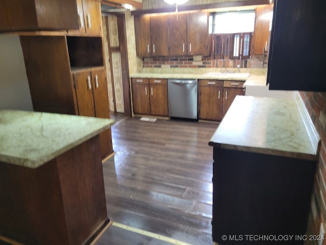 kitchen with stainless steel dishwasher, backsplash, and dark wood-type flooring