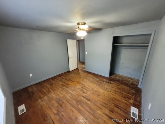 unfurnished bedroom featuring a closet, ceiling fan, and wood-type flooring